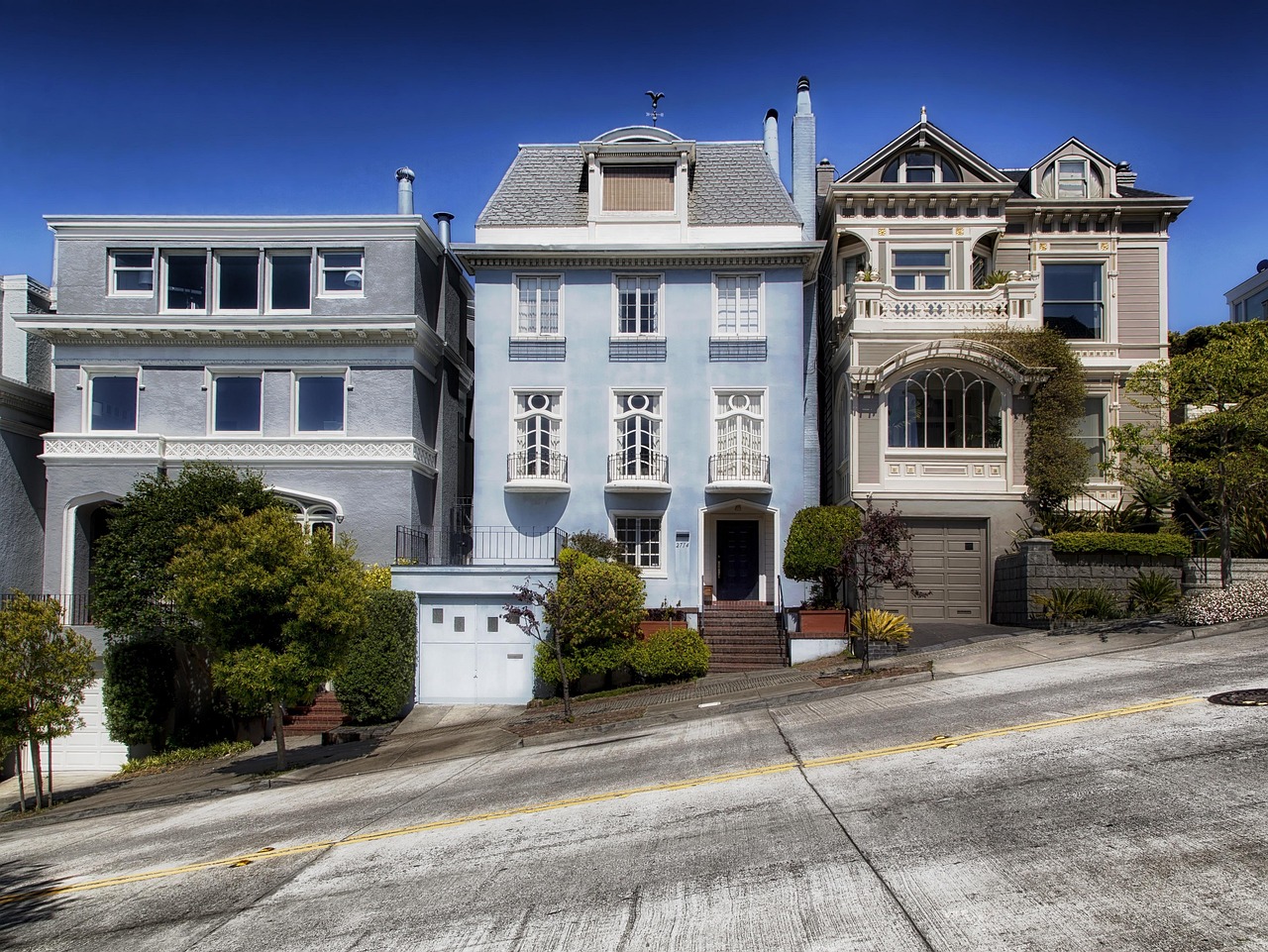Residential street with mature trees and single-story homes